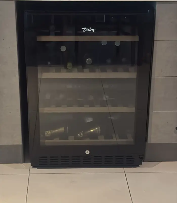 Professional wine cooler repair in Dubai - expert technician servicing luxury wine storage unit